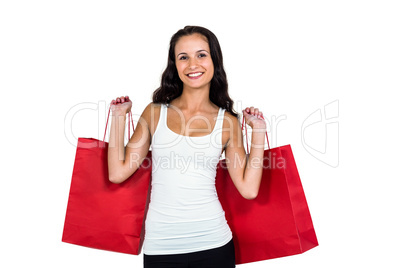 Smiling woman holding red shopping bags