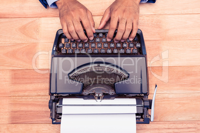 High angle view of businessman typing on typewriter
