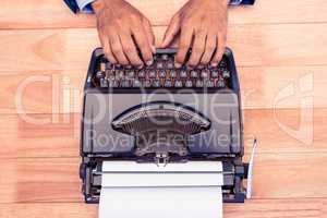 High angle view of businessman typing on typewriter