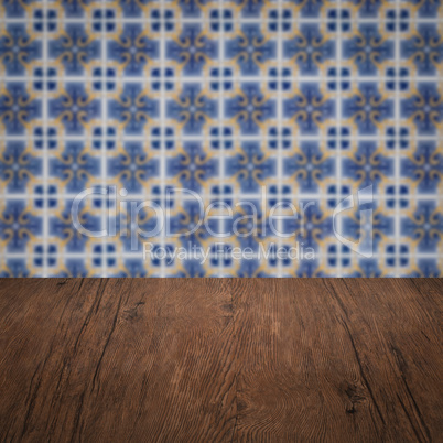 Wood table top and blur vintage ceramic tile pattern wall