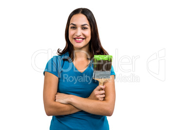 Portrait of smiling woman holding paint brush
