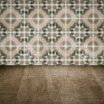 Wood table top and blur vintage ceramic tile pattern wall