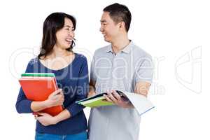 Couple smiling at each other while holding books