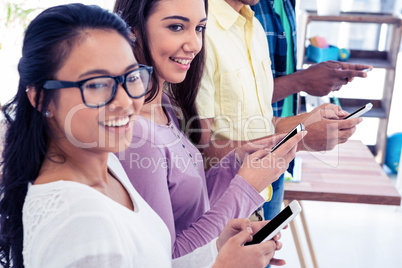 High angle view of businesswomen with colleagues using phone