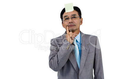 Businessman with blank note on forehead
