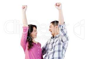 Cheerful young couple with hands raised