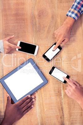 Business colleagues using technologies at desk