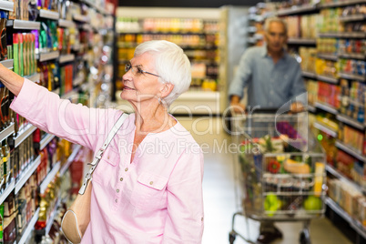 Senior woman picking out product