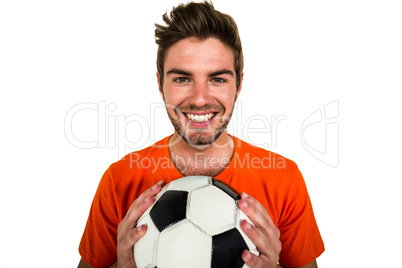 Handsome supporter holding football ball