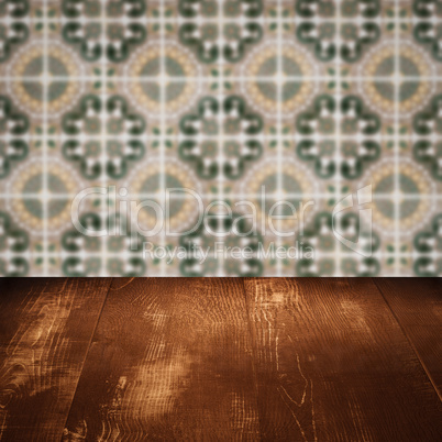 Wood table top and blur vintage ceramic tile pattern wall