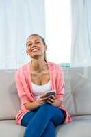 Smiling woman holding smartphone