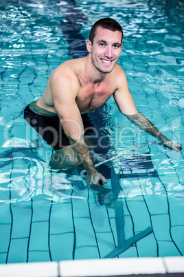 Fit man cycling in the pool