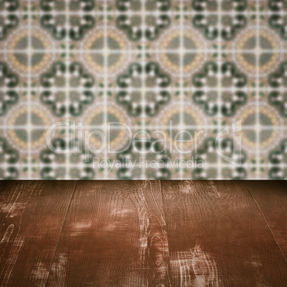 Wood table top and blur vintage ceramic tile pattern wall