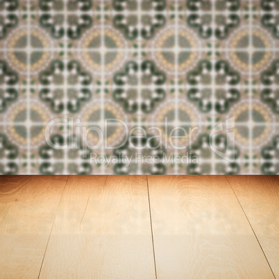 Wood table top and blur vintage ceramic tile pattern wall