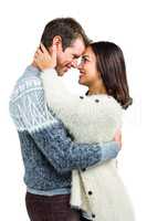 Cheerful couple in warm clothing embracing each other