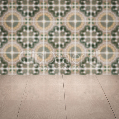 Wood table top and blur vintage ceramic tile pattern wall