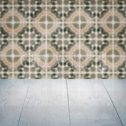 Wood table top and blur vintage ceramic tile pattern wall