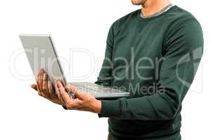 Midsection of man holding laptop