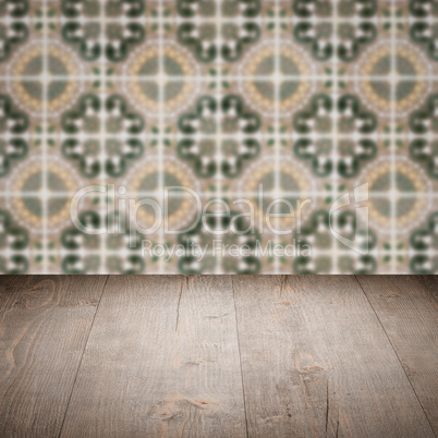 Wood table top and blur vintage ceramic tile pattern wall Wood table top and blur vintage ceramic tile pattern wall
