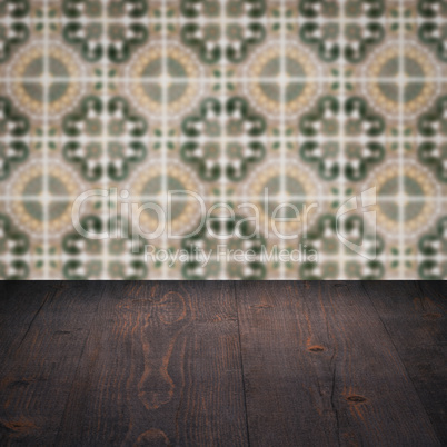 Wood table top and blur vintage ceramic tile pattern wall Wood table top and blur vintage ceramic tile pattern wall