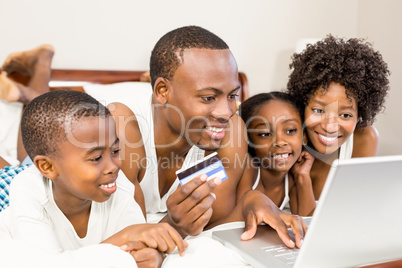 Happy family lying on the bed