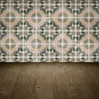 Wood table top and blur vintage ceramic tile pattern wall