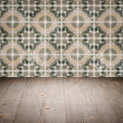 Wood table top and blur vintage ceramic tile pattern wall Wood table top and blur vintage ceramic tile pattern wall