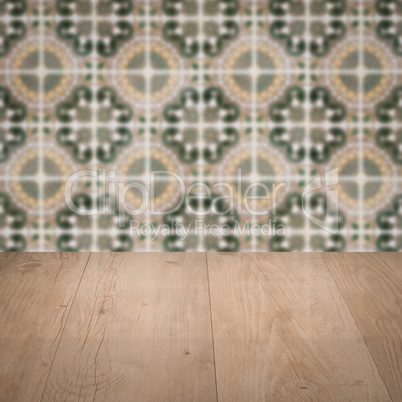 Wood table top and blur vintage ceramic tile pattern wall