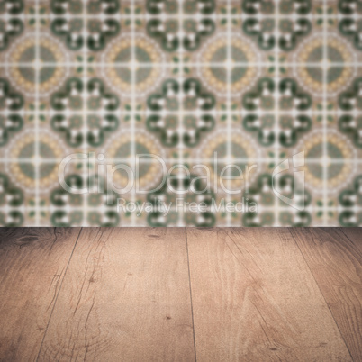 Wood table top and blur vintage ceramic tile pattern wall