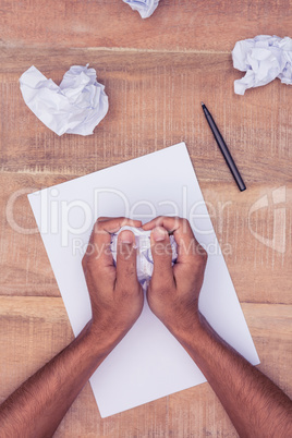 Businessman making paper balls