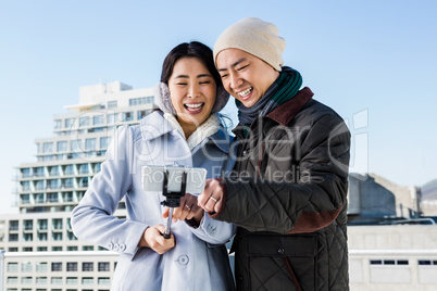 Couple laughing while viewing pictures