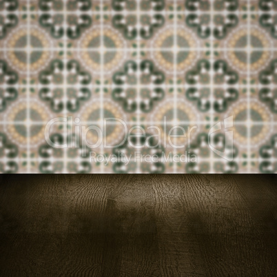 Wood table top and blur vintage ceramic tile pattern wall