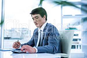 Concentrated asian businessman is working