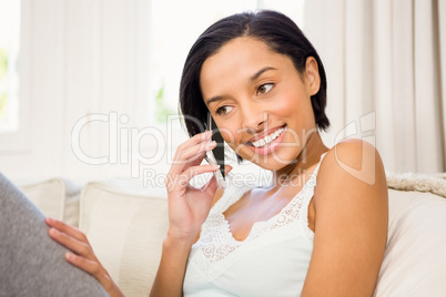 Smiling brunette on a phone call