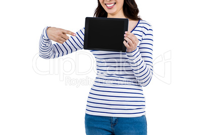 Mid section of woman pointing at tablet computer