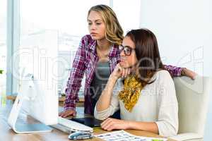 Two girls use a computer