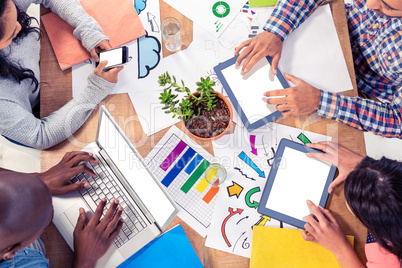 Business colleagues using technologies at desk