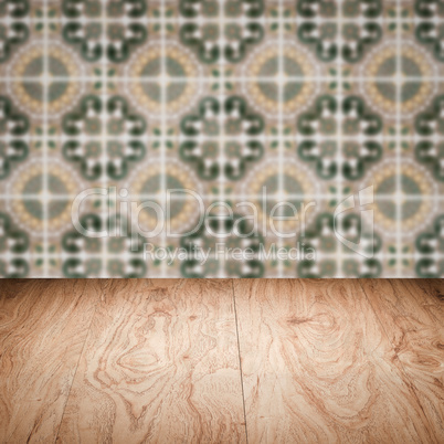 Wood table top and blur vintage ceramic tile pattern wall