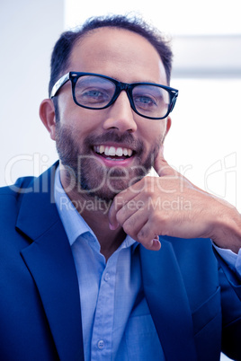 Portrait of happy businessman in creative office