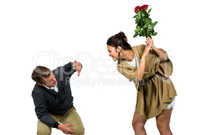 Woman hitting boyfriend with red flowers