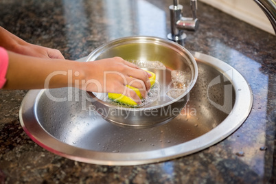 Close up of woman cleaning pot