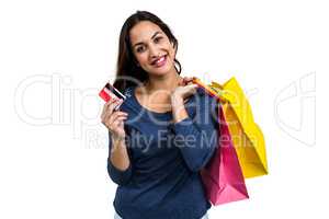 Portrait of happy young woman with shopping bags and payment car