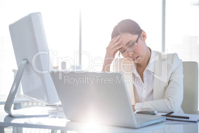 Stressed businesswoman working at her desk