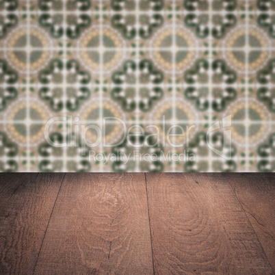 Wood table top and blur vintage ceramic tile pattern wall