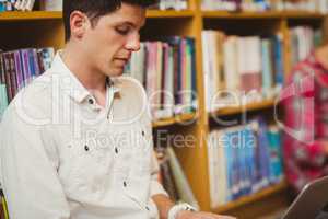 Concentrated male student working on floor