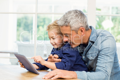 Father and son using tablet