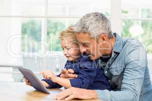 Father and son using tablet