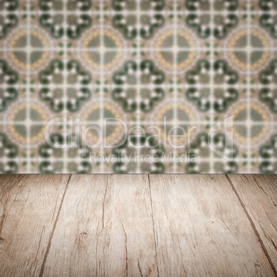 Wood table top and blur vintage ceramic tile pattern wall