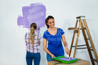 Friends painting a wall