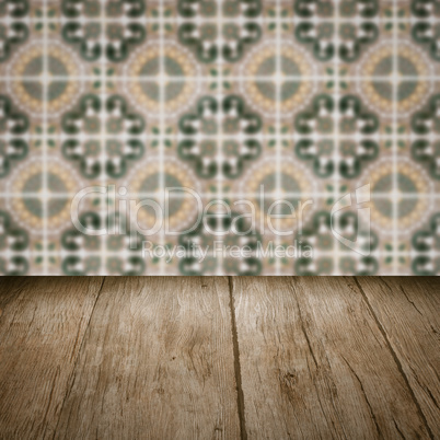 Wood table top and blur vintage ceramic tile pattern wall